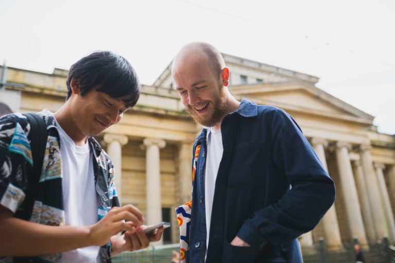 Two men looking at a phone
